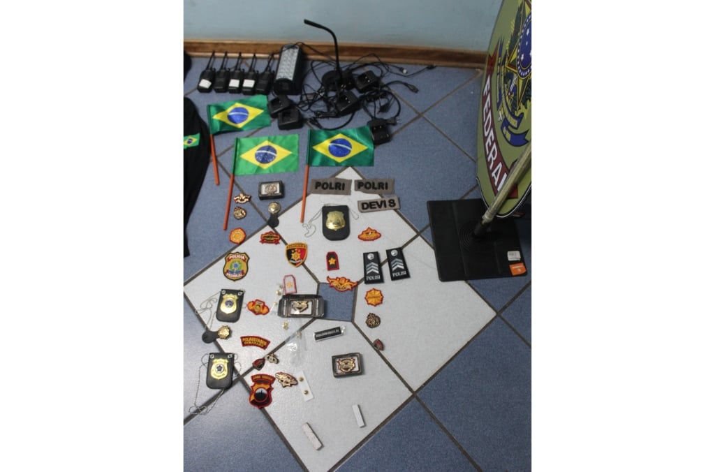 Seized items from an Eswatini scam centre (fake uniforms, electronic devices) recovered during INTERPOL&rsquo;s Operation First Light &mdash; visual evidence of physical scam hubs that feed proceeds into virtual wallets.
