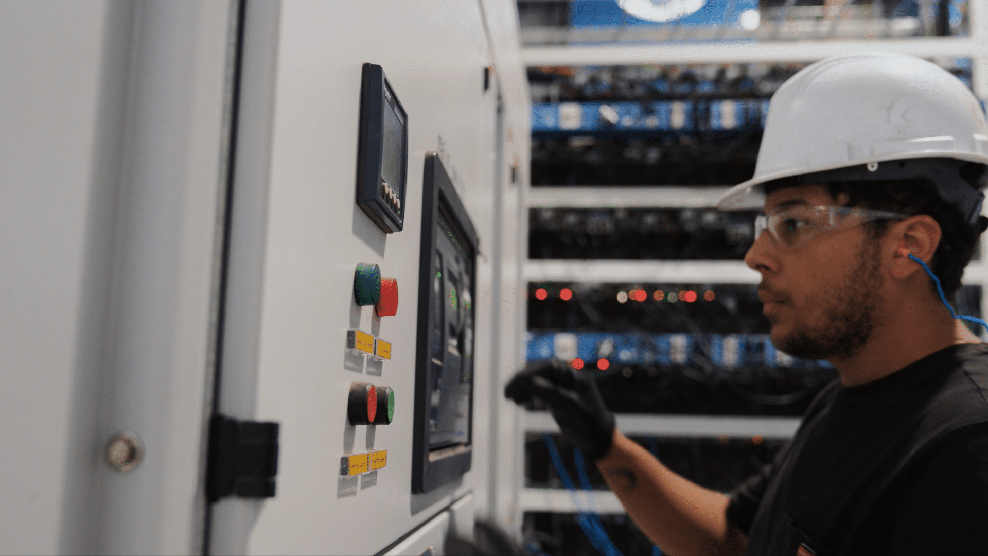 Fortitude mining-facility operations image showing ASIC mining equipment and a technician.