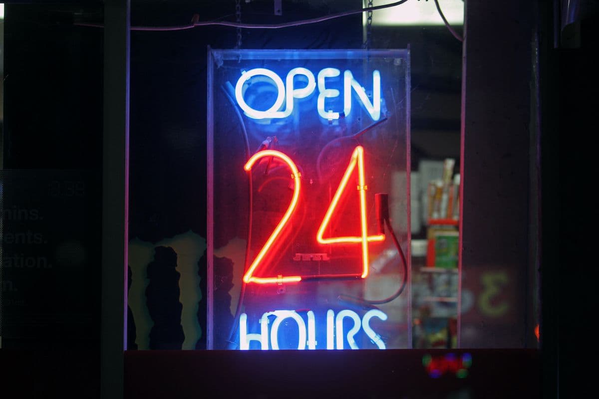 CoinDesk&rsquo;s header image (neon &lsquo;Open 24 Hours&rsquo;) illustrating the 24/7 trading and settlement ambition for Metaplanet&rsquo;s bitcoin‑backed digital credit study &mdash; useful as a visual shorthand for the project&rsquo;s around‑the‑clock market goal.